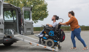 man in his wheelchair while being transported to a van