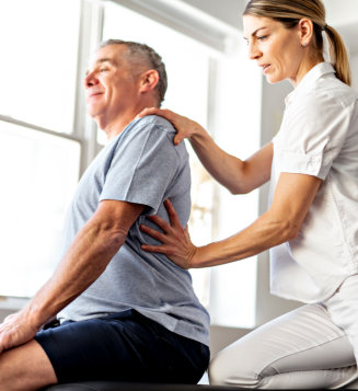  A Modern rehabilitation physiotherapy worker with senior client