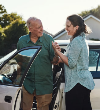 Travel, transportation and happy women helping elderly male person from motor vehicle for service