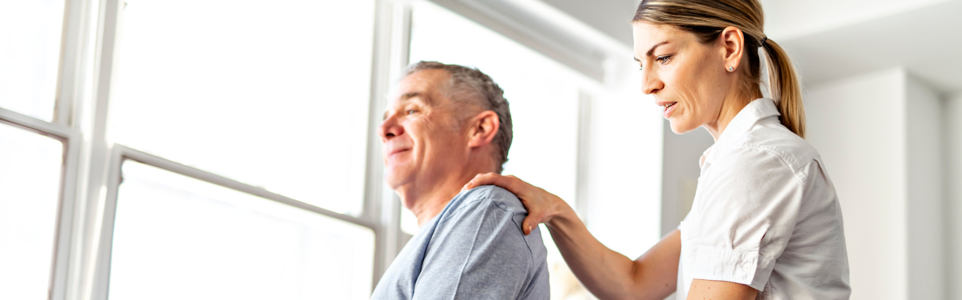 A Modern rehabilitation physiotherapy worker with senior client